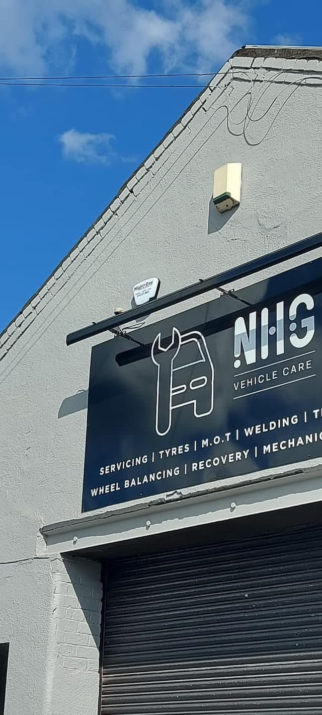 NHG Vehicle Care sign listing servicing, tyres, MOT, welding, wheel balancing, recovery and mechanic services
